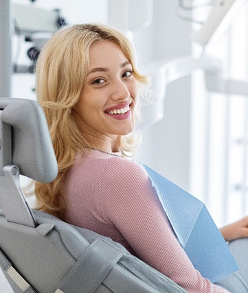 Woman smiling while sitting in treatment chair