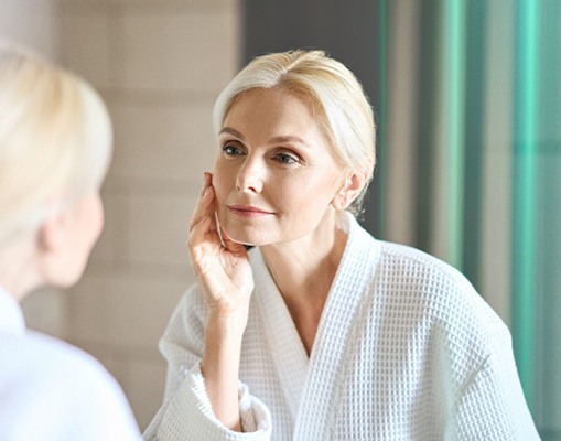 Patient in Frisco looking at face in mirror