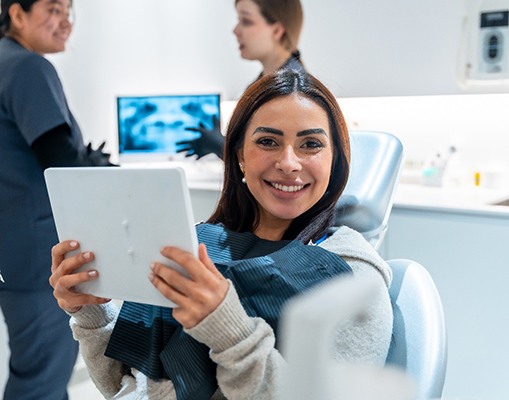 A woman looking at her payment options on a tablet