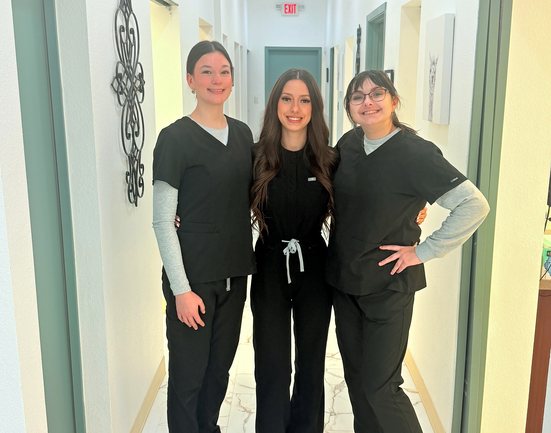Three Highland Oak Dental team members in the hallway of our Frisco dental office
