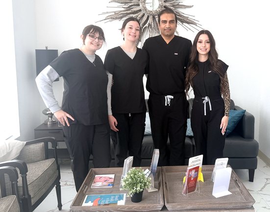 Dr. Prakash Gadhiya and the Highland Oak Dental team in the Frisco office lobby