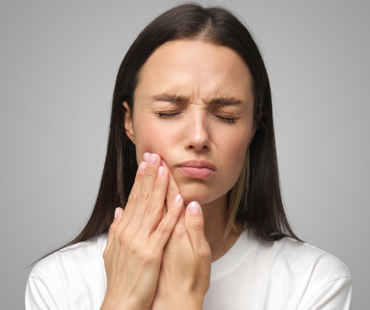Woman holding jaw in pain