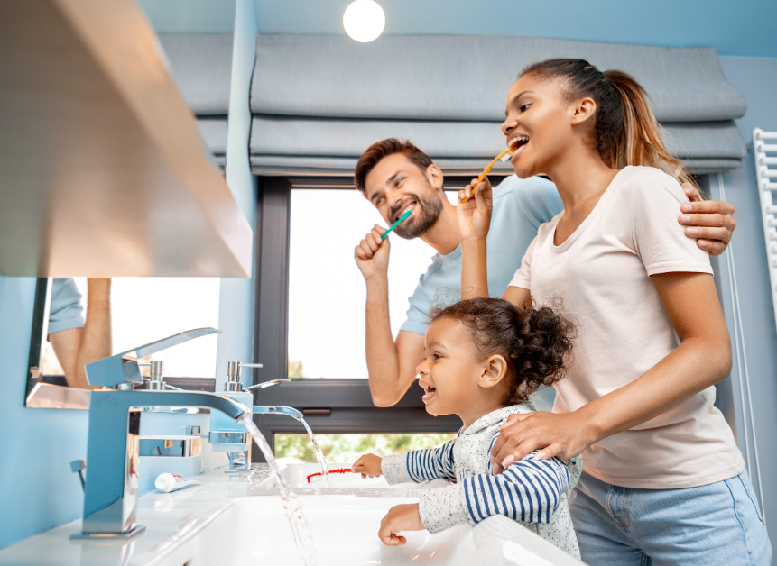Family brushing teeth together