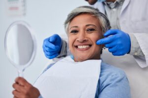 Older woman smiling after cosmetic dental treatment