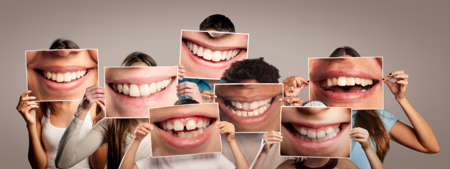 Group photo of people holding photographs of smiles over their faces